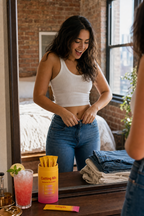 Woman fitting into her old jeans in the mirror with Cuttea Cutting Mix on the dresser