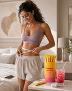 Woman measuring her waist beside Cuttea Cutting Mix tub and strawberry acai drink